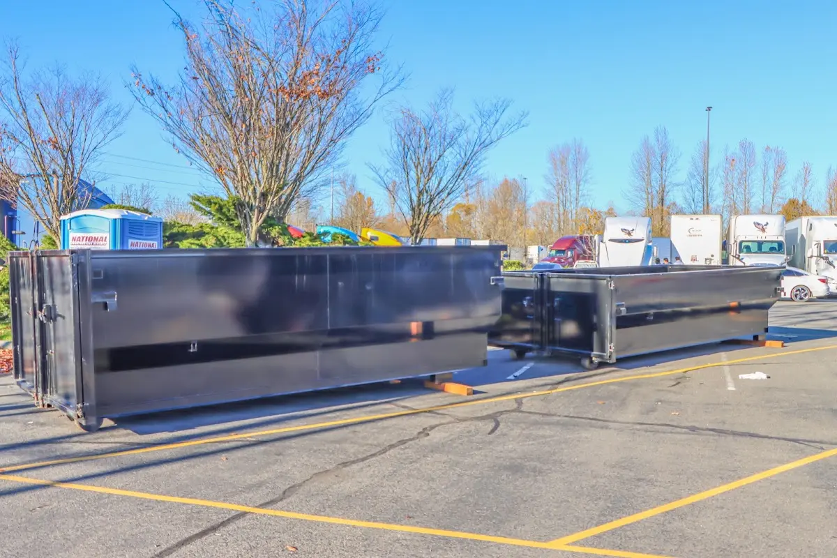 Professional dumpster rental service with roll-off container on residential driveway in Germantown